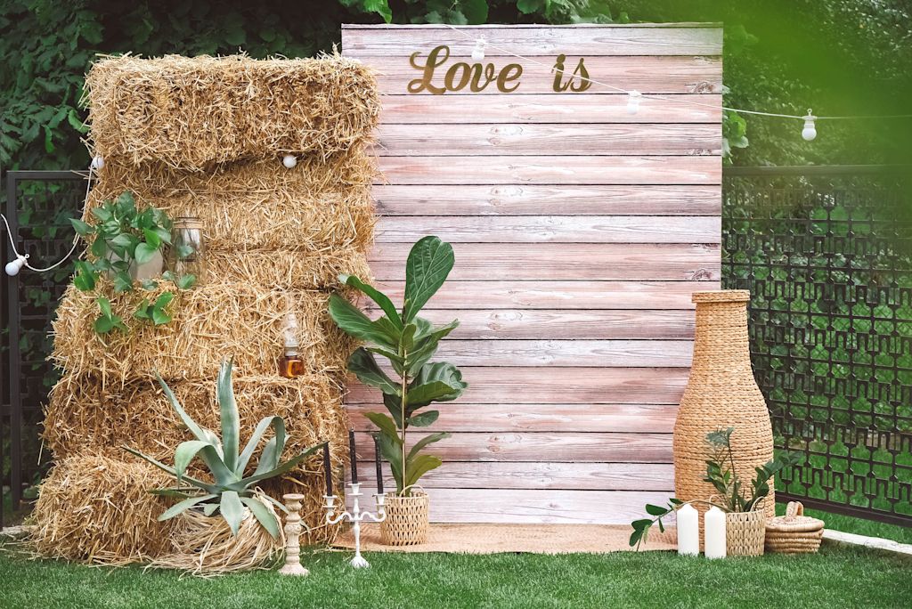 Wooden wedding sign idea with "Love is" written in script font