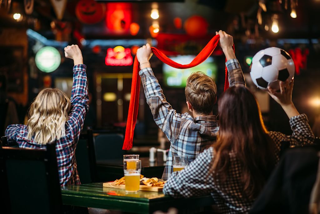 People watching a football match at a bar