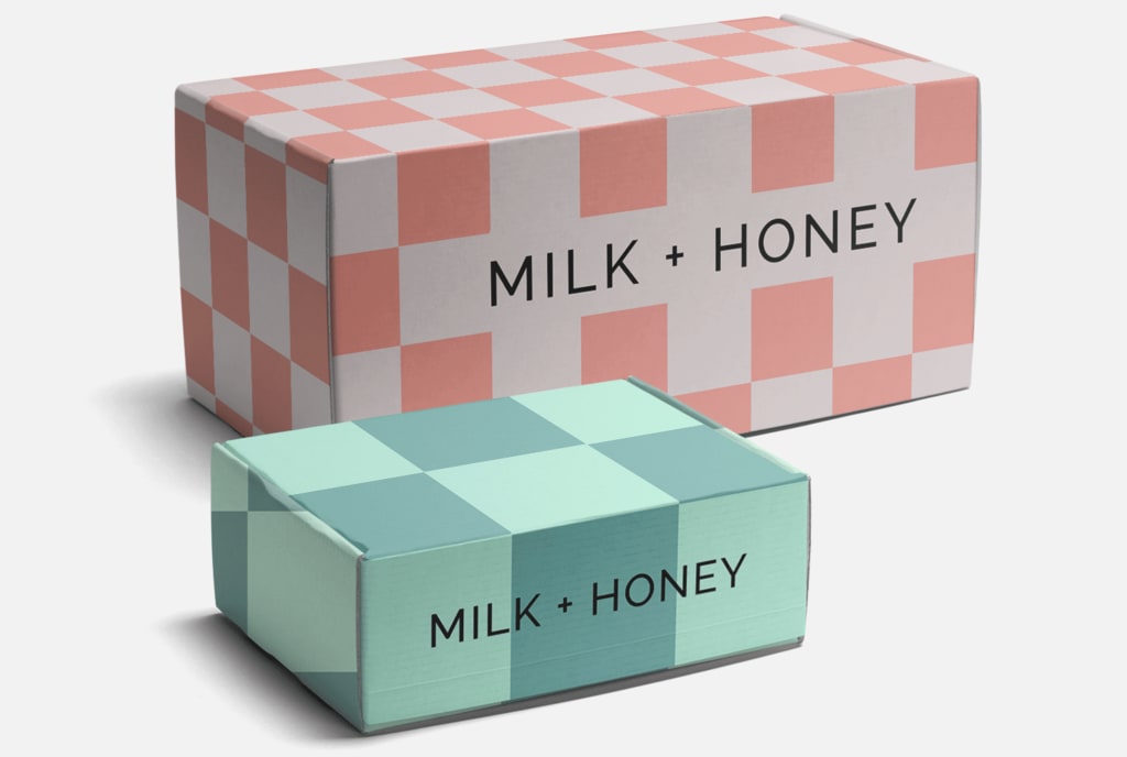 A large pink and small blue mailer box, both with simple checker design and black font on front panel.