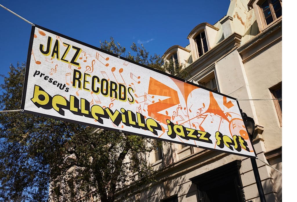 Banner promoting a jazz festival hanging high above a street
