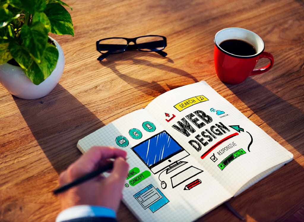 hand draws colorful wireframes of web design