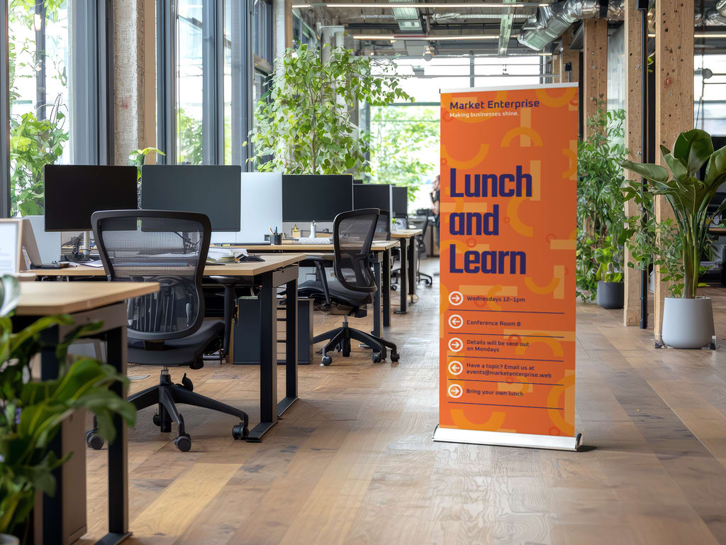 Retractable banner advertising an employee event in an office