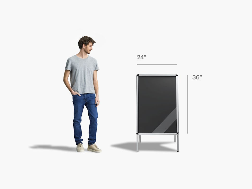 Standard 24" x 36" A-frame size next to a person for size reference—almost as tall as their armpit.