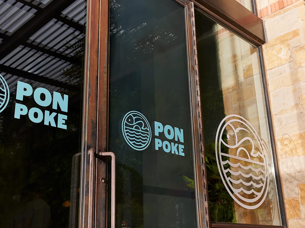 Branded window decals in storefront design.