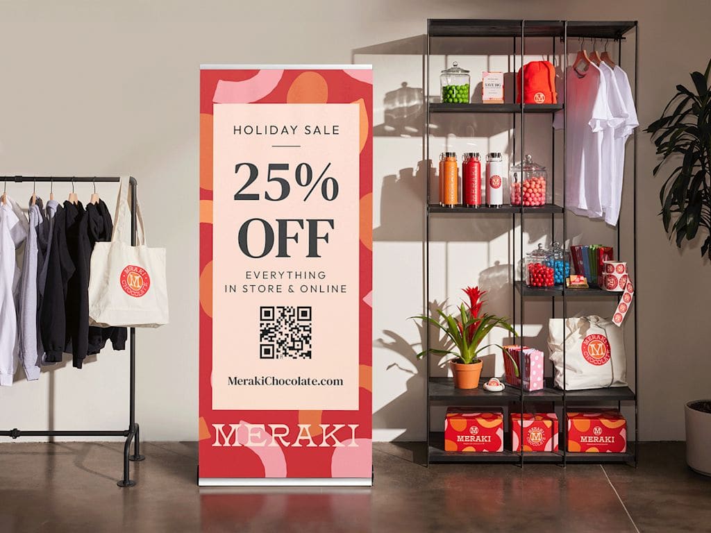 Retractable banner in clothing store advertising holiday sale
