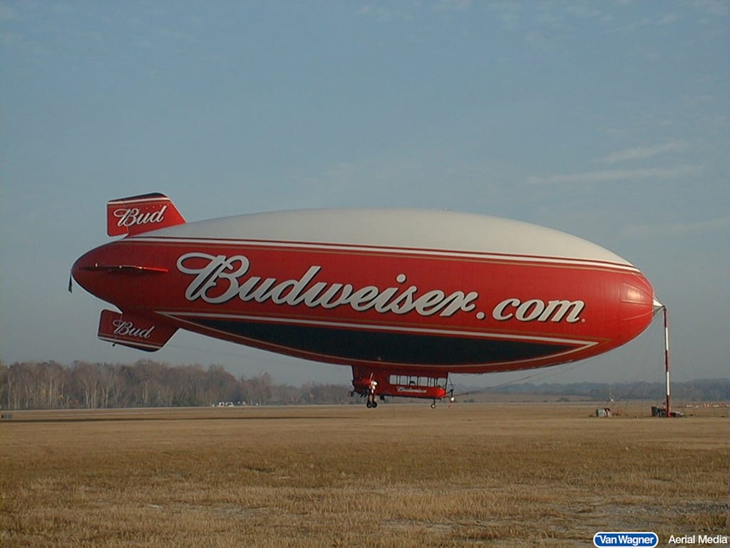 A large blimp with ‘Budweister.com’ advertised on the side