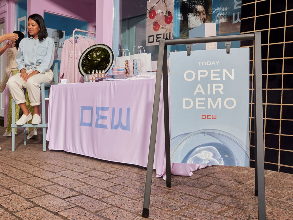 A-frame sign inviting passers-by to an open air demo event, part of event marketing promotion