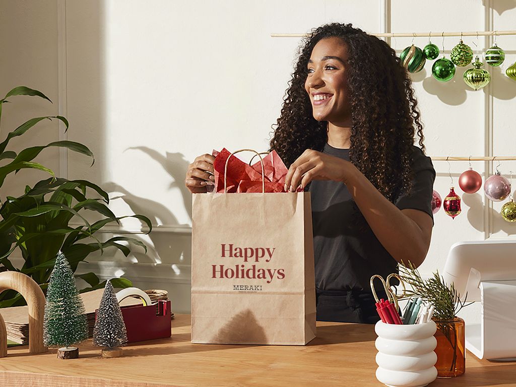 woman filling a brown paper shopping bag on Black Friday