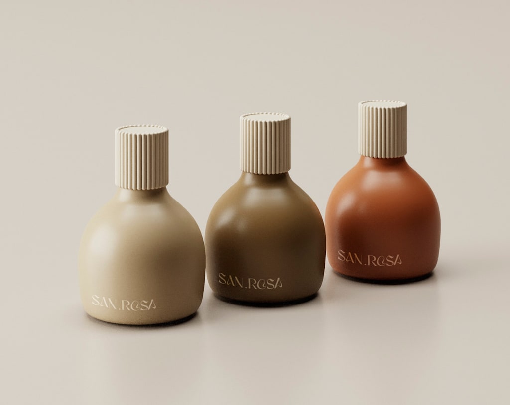 Three round cosmetics bottles in shades of brown going from light taupe to chocolate brown to burnt orange