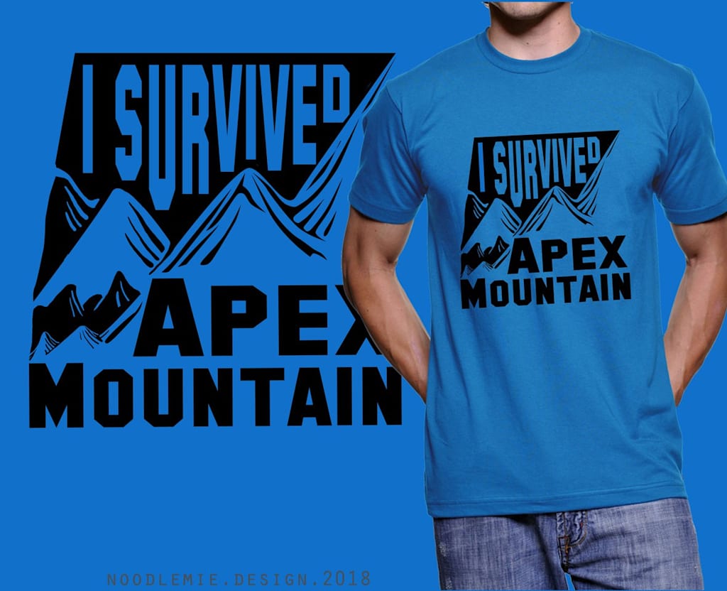 Blue T-shirt with black graphic of mountains and font “I SURVIVED APEX MOUNTAIN.”