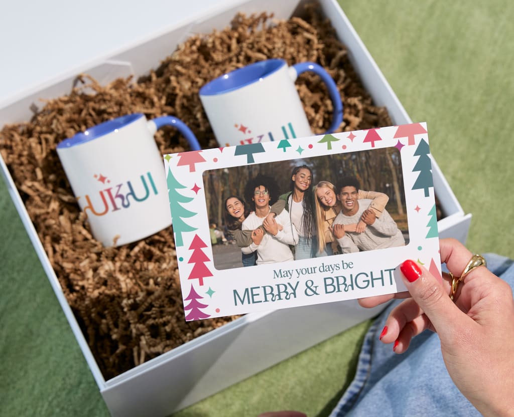 Branded mugs and a personal card as example of holiday giveaway with store purchase
