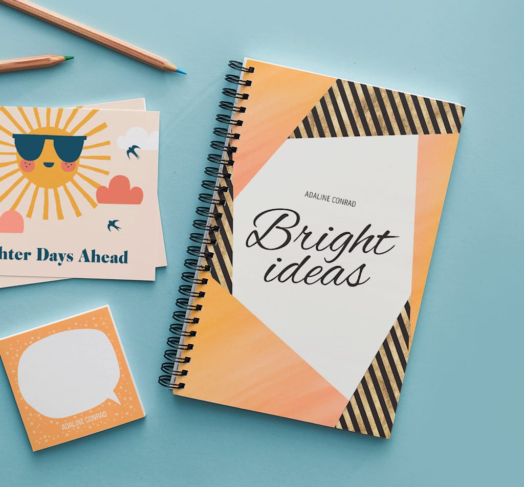 orange notebook with bright ideas written on the front