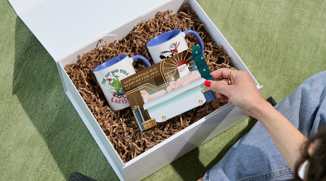 hand opening gift basket to see christmas card