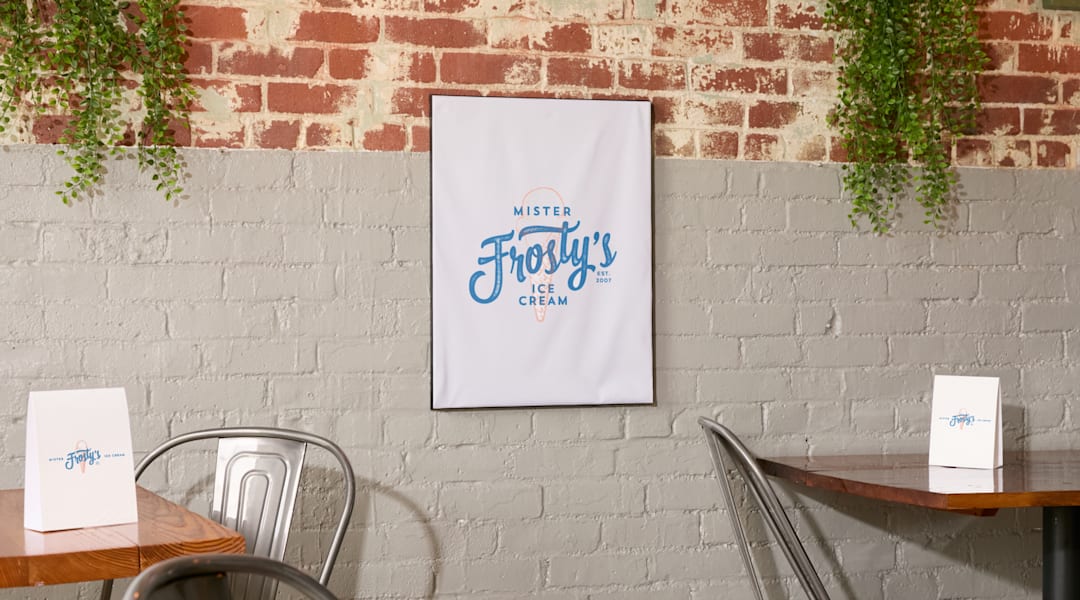 A white poster on a brick wall, advertising ice cream using the Pantone Color of the Year