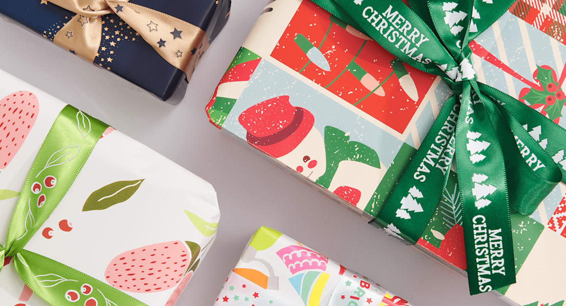Christmas gifts wrapped in bright patterned paper and ribbon