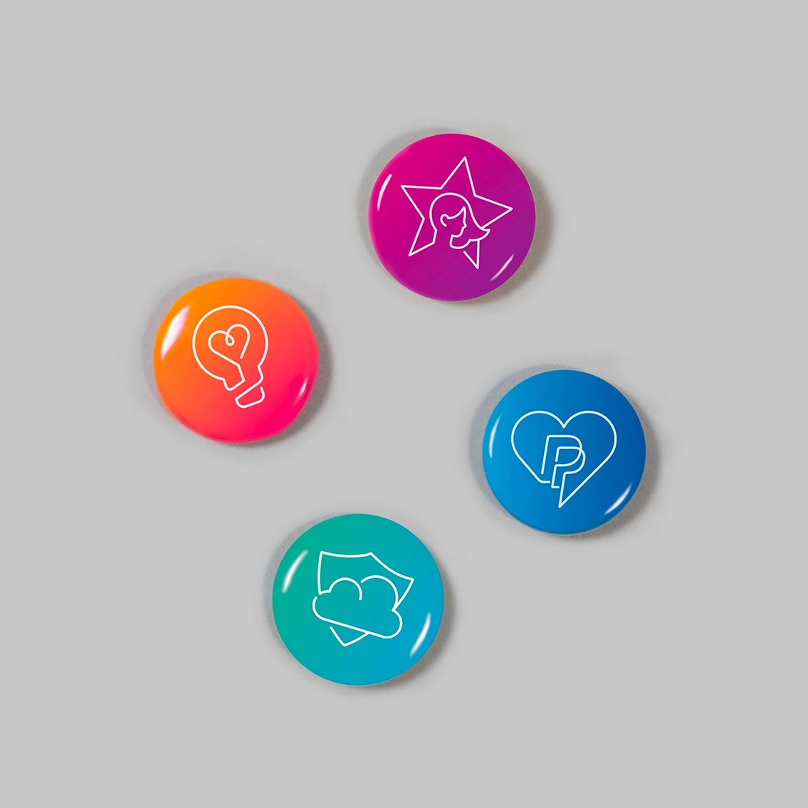 4 badges with different line illustrations on them
