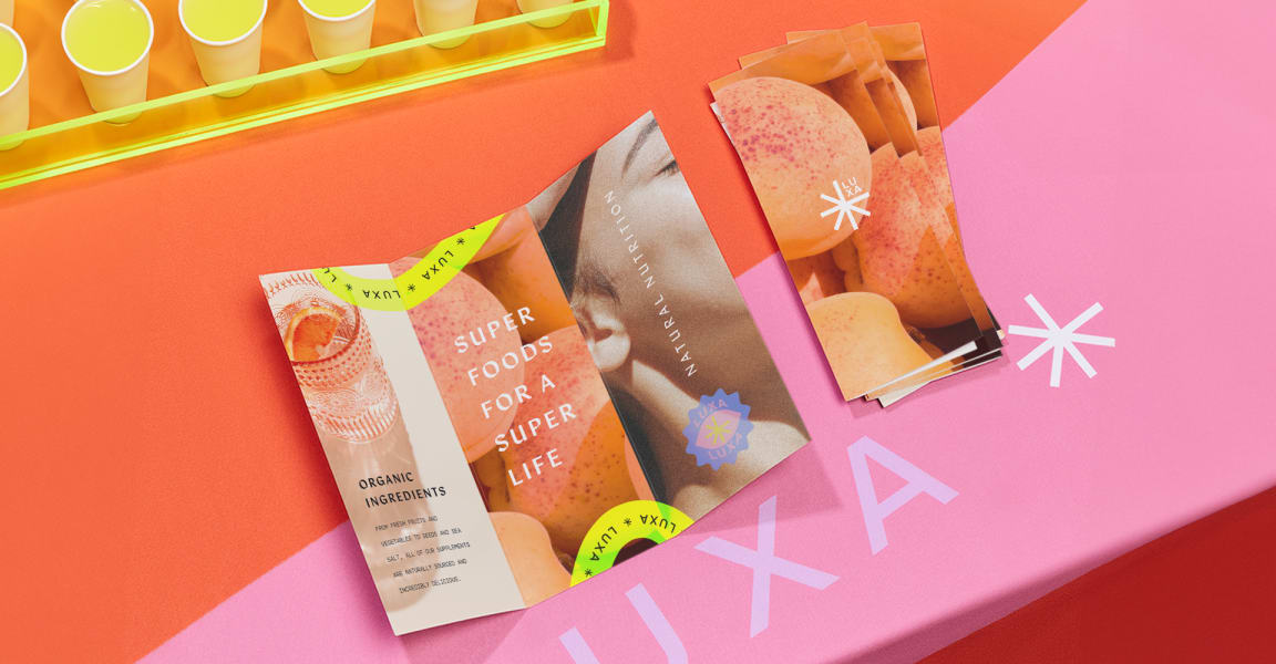 Tri-fold marketing piece displayed on a colorful surface, example comparison for flyer vs brochure print materials