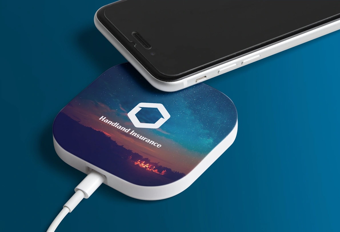 A charging pad next to a smartphone