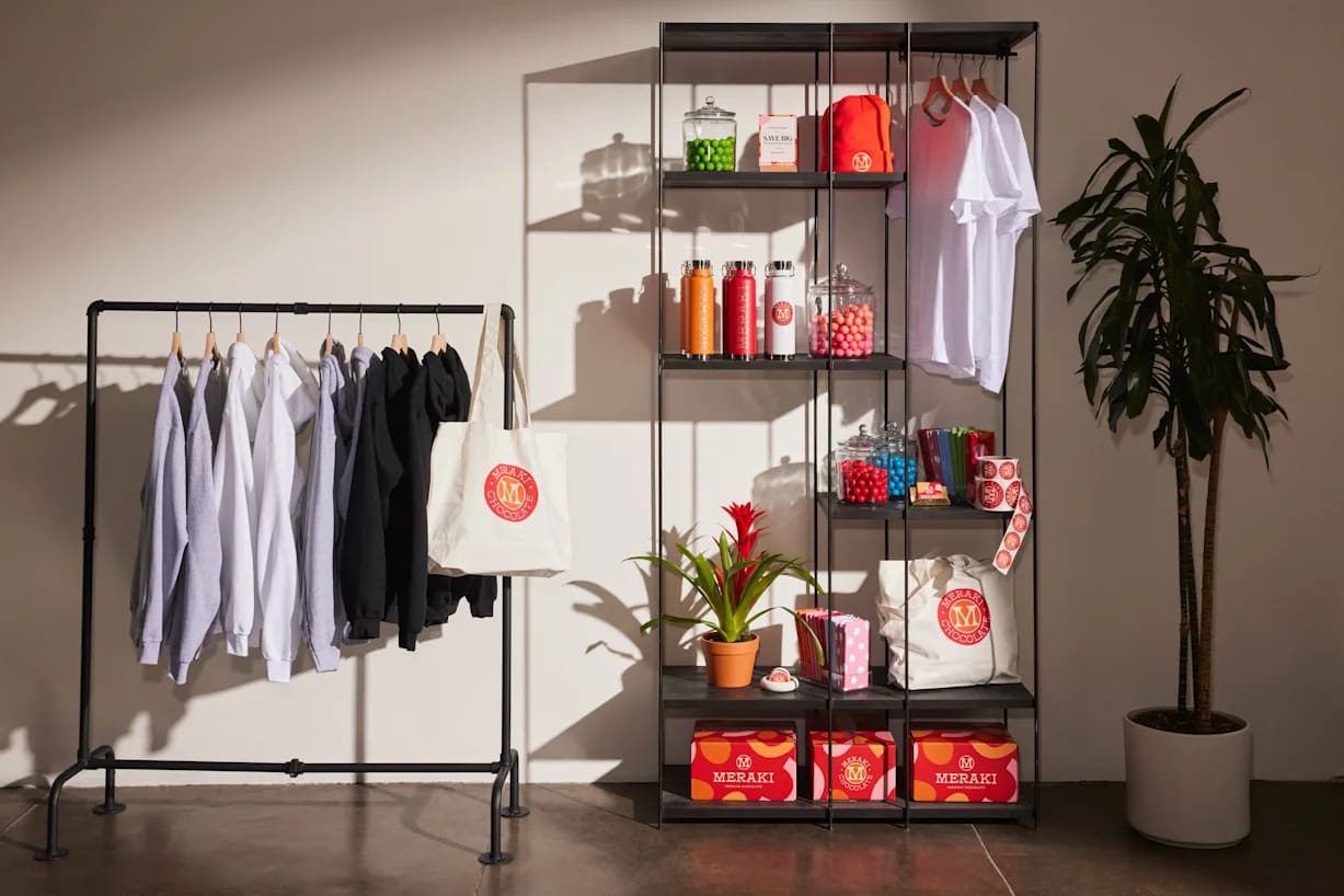 a clothing rack with hanging t shirts with custom designs