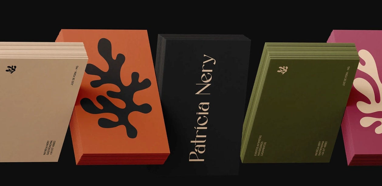 Set of different colored business cards in warm tones of orange, green, black and pink