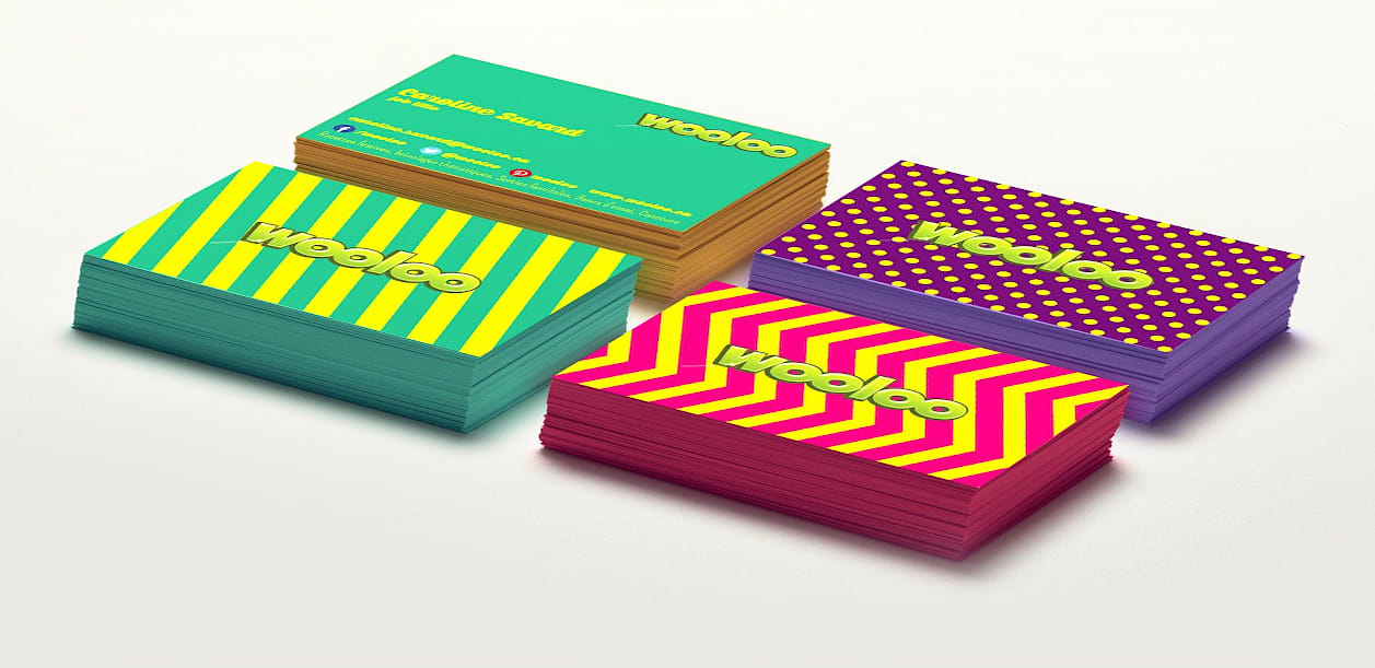 Set of different colored business cards in warm tones of orange, green, black and pink
