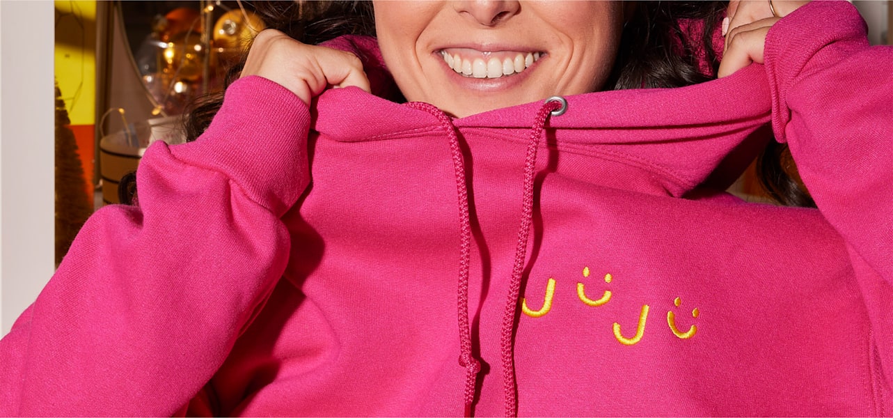 Barbiecore trend: a woman wearing a hot pink hoodie
