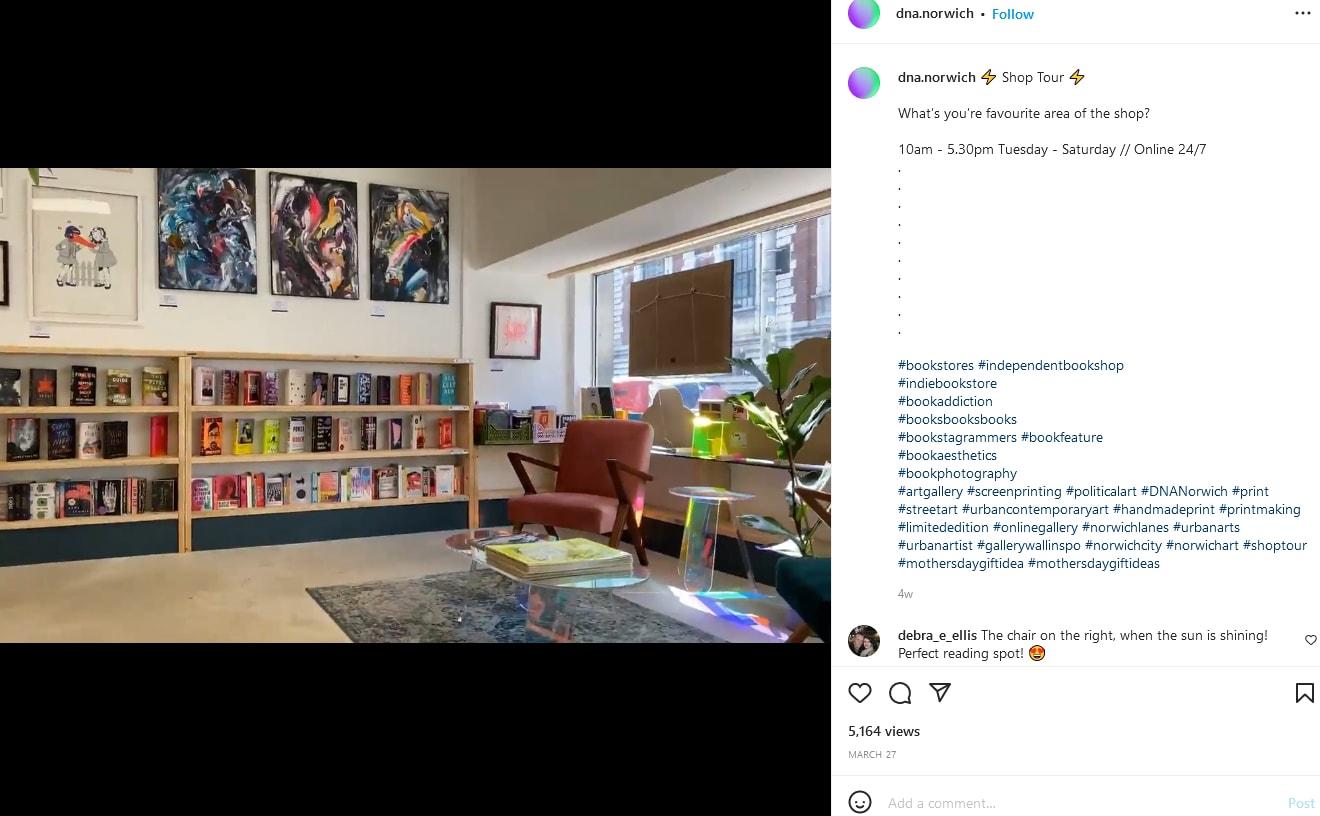 An orange reading chair with shelves of books in the background