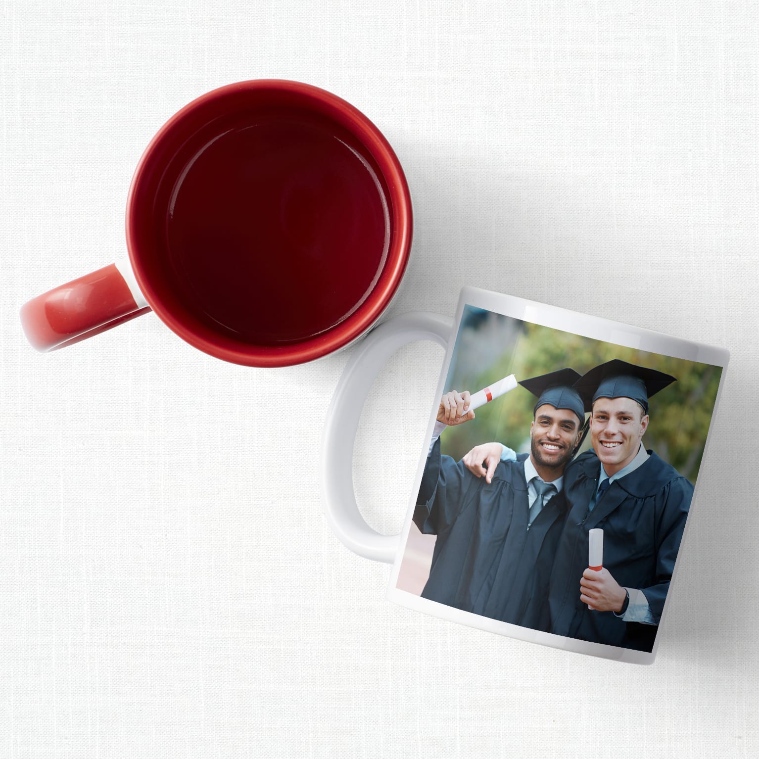 Two custom mugs one featuring a photo of two graduates