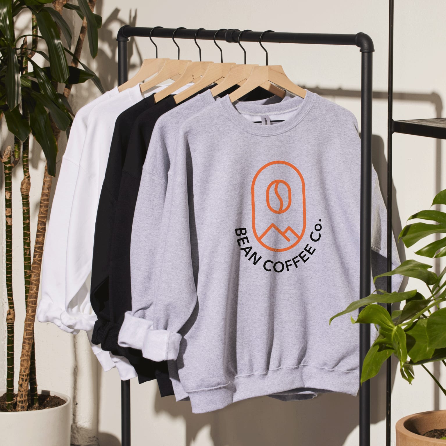 Hoodies on a clothing rack.