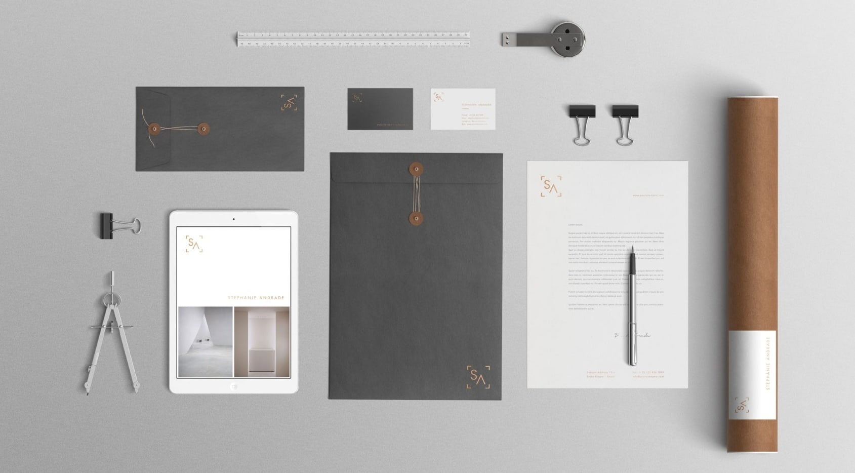 Collection of envelopes, tools, stationary and business cards showing an architecture firm&rsquo;s branding