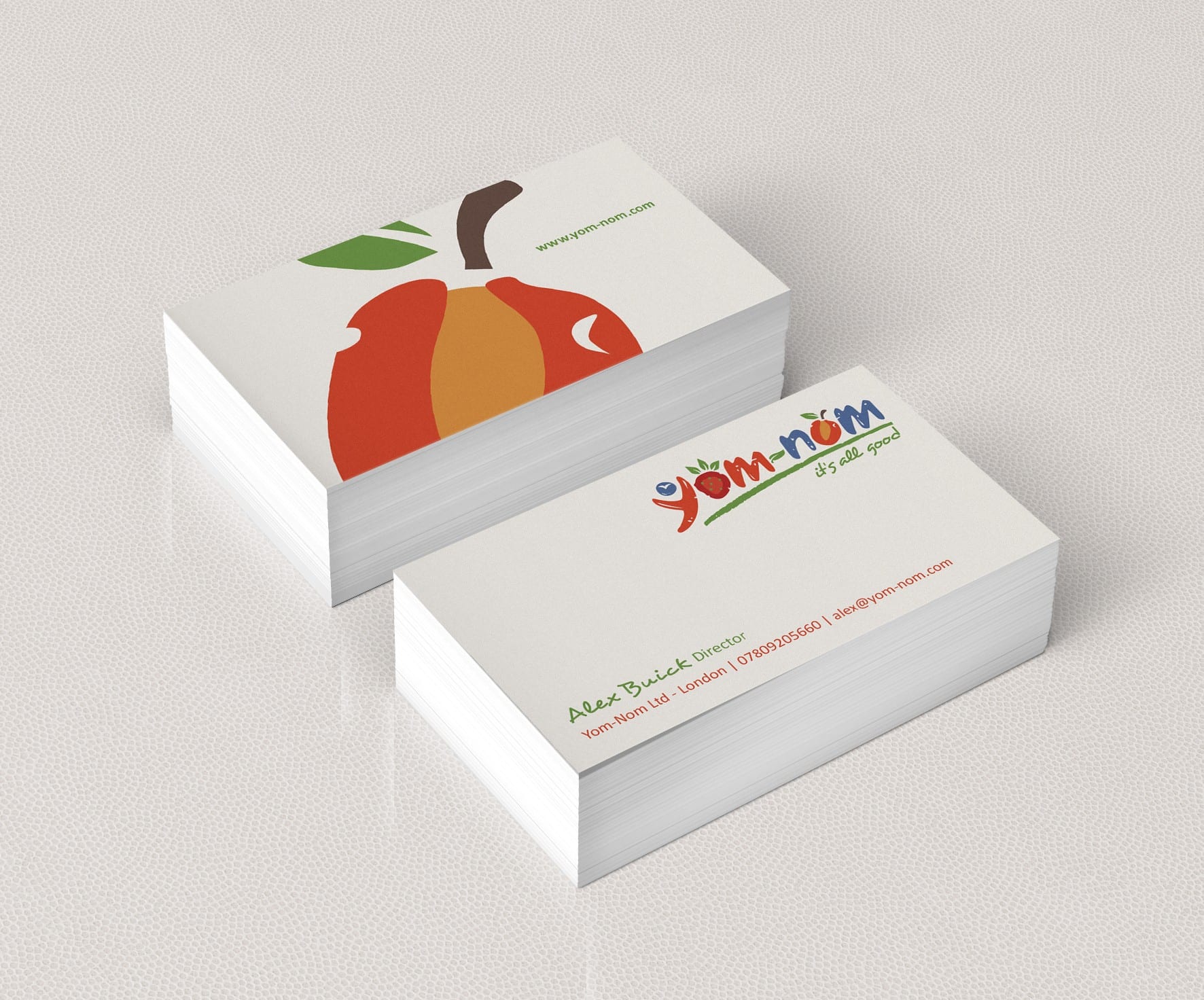 White business card with red apple.
