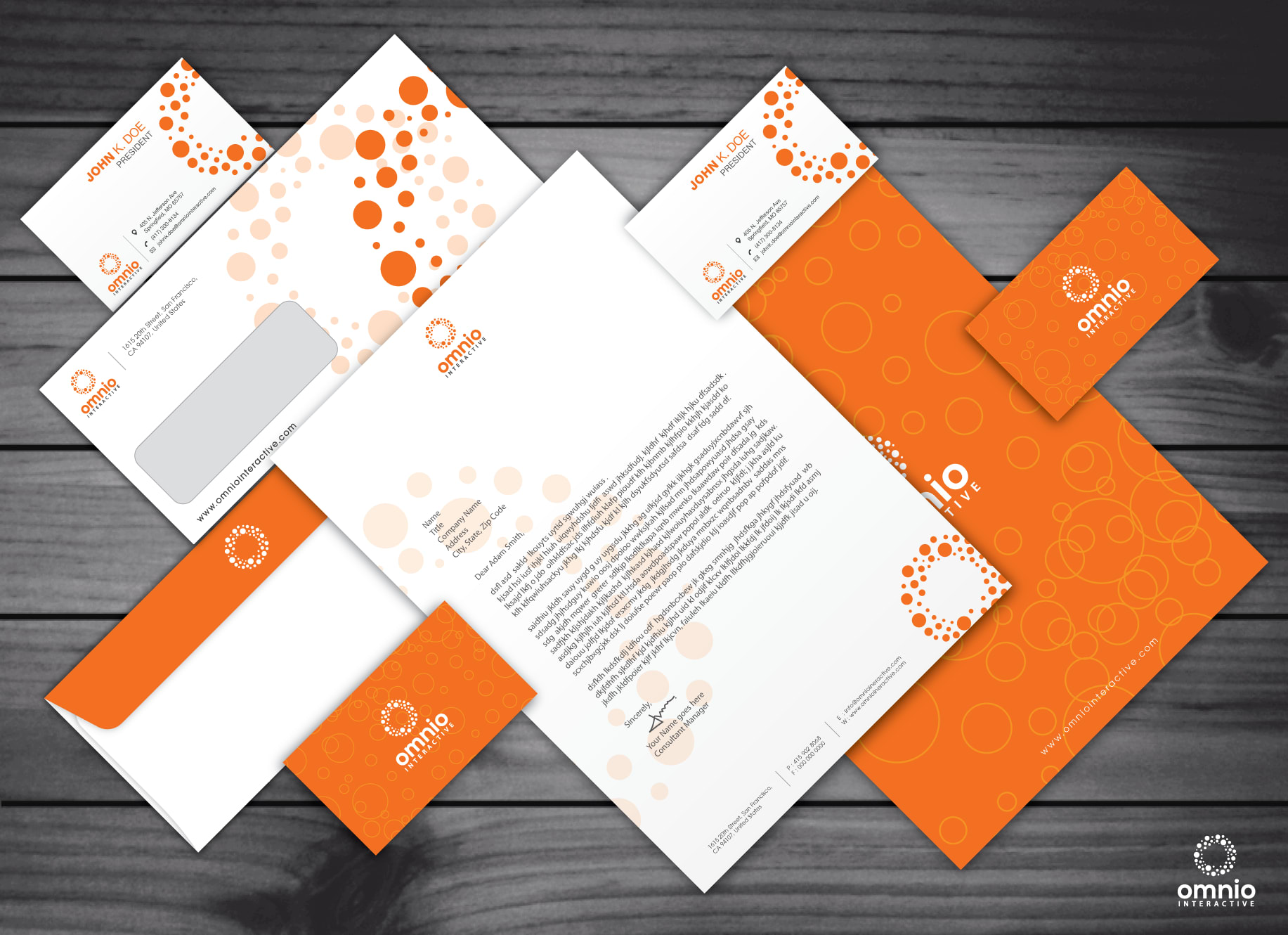 orange and white-patterned stationery, envelopes, and business cards