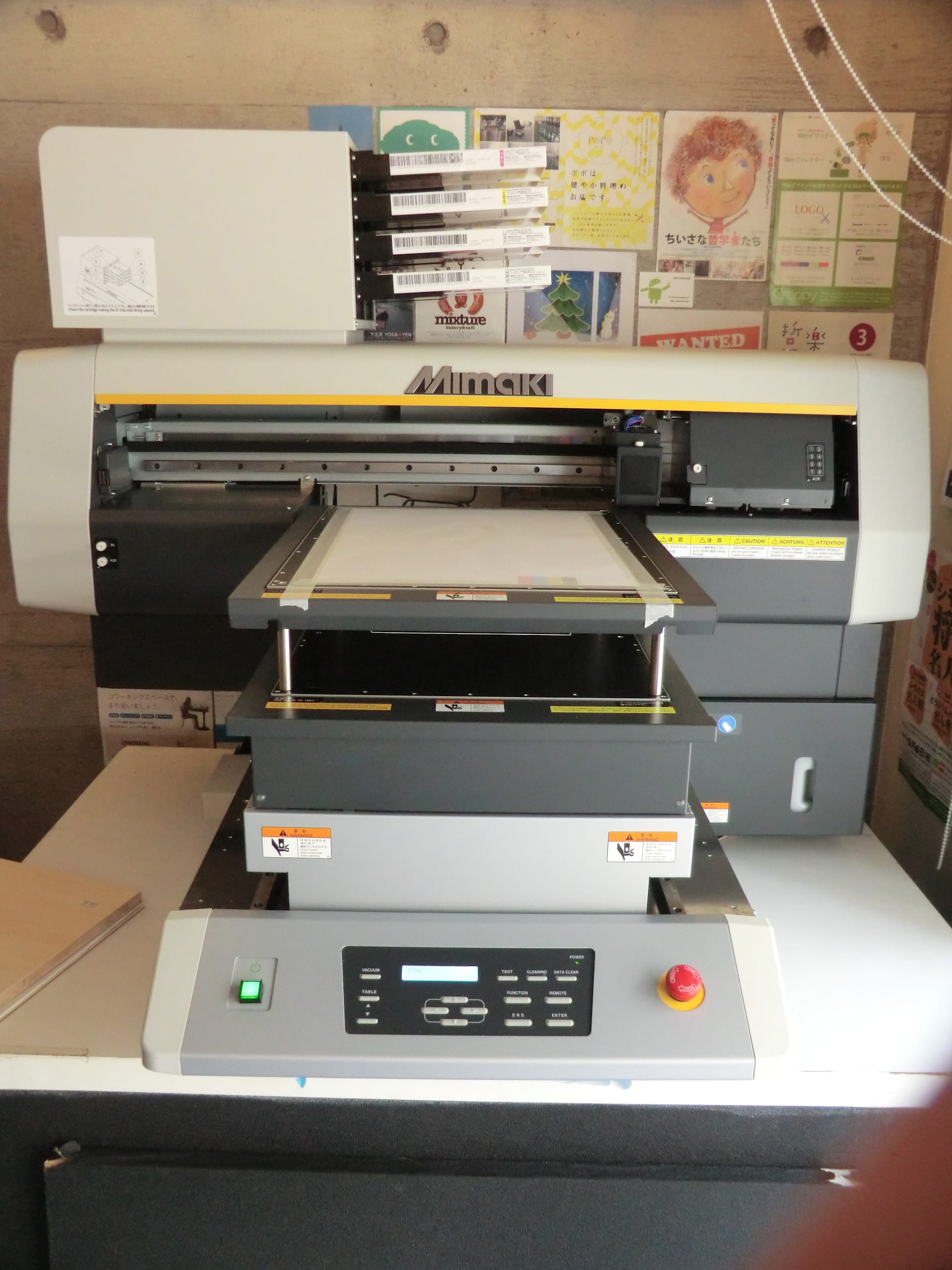 A Mimaki UJF 3042HG LED UV printer sitting on top of a desk