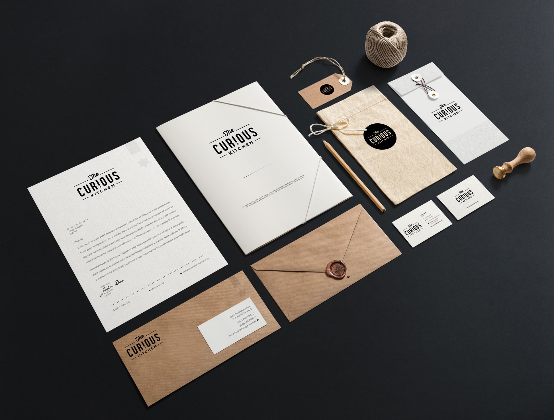 Brand collateral showing letterheads, envelopes, business cards and tags