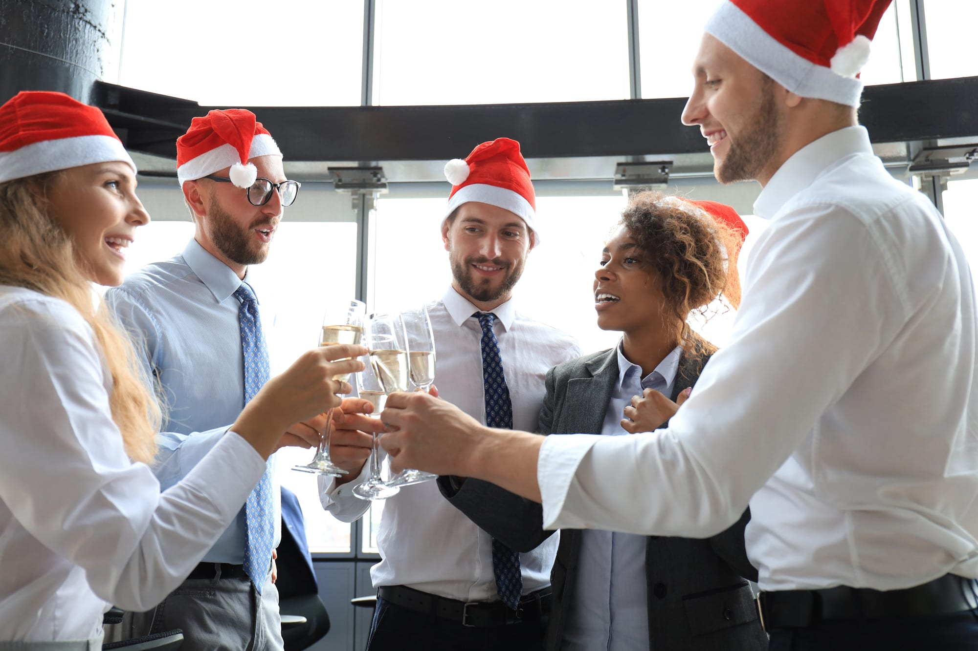 office team members cheersing for the holiday season