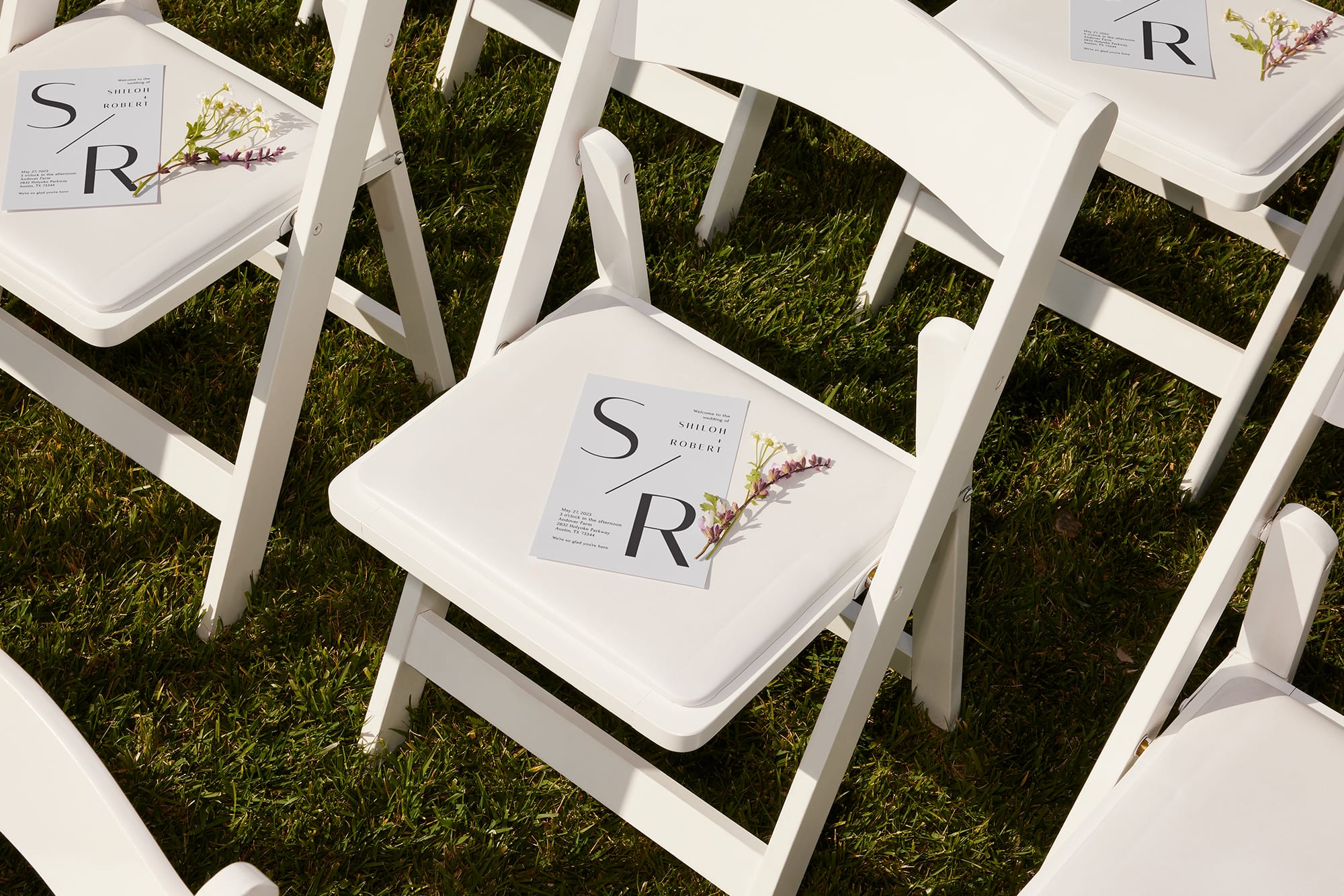 Custom wedding stationery on chairs