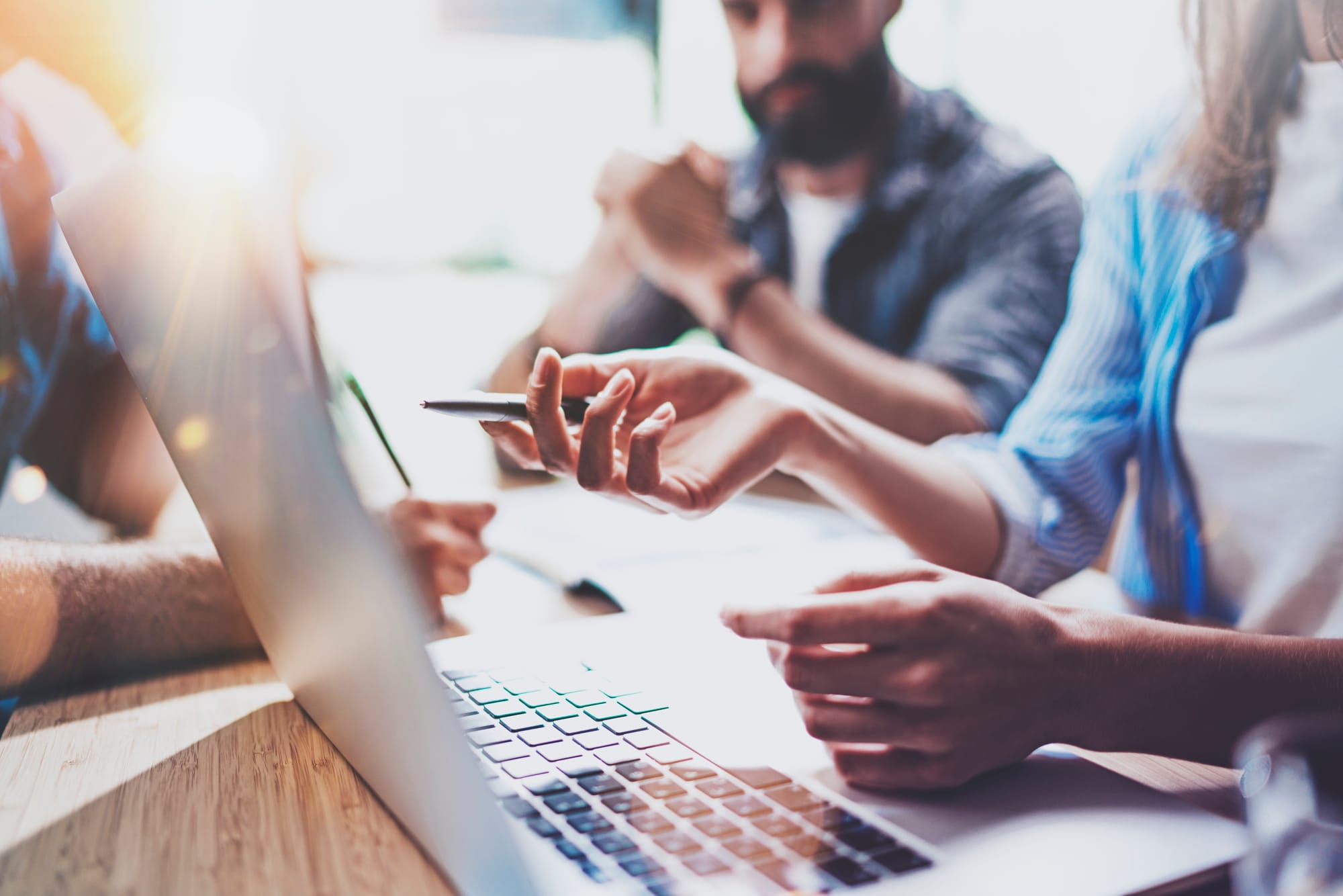 People looking at a computer thinking of goals for their marketing plan