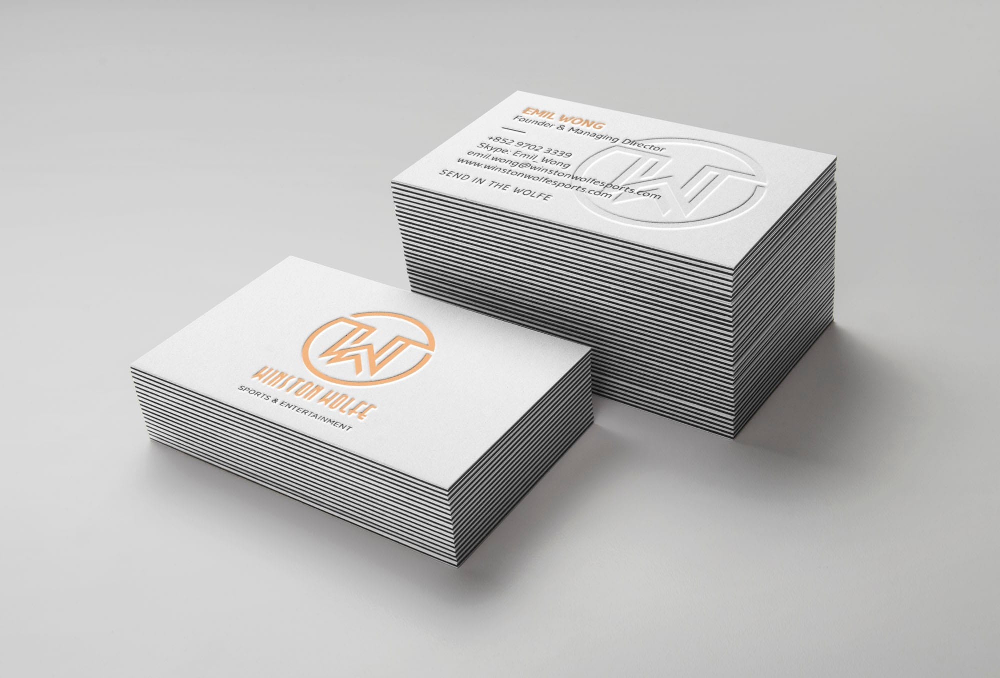 White business card with gold embossed text and logo