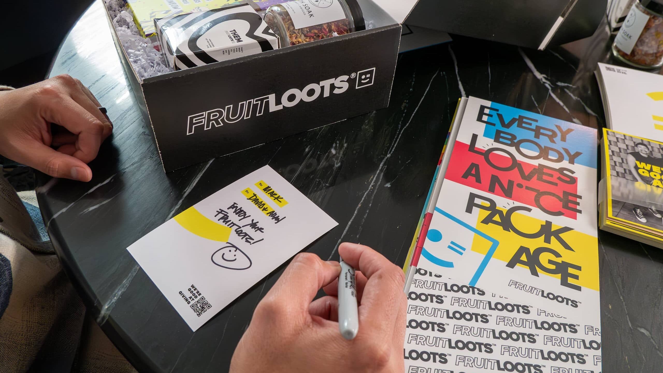 Branded postcards with hand-written notes that follow the brand’s tone of voice, branded packaging that uses brand colors and logo – a manifestation of a brand style guide in practice