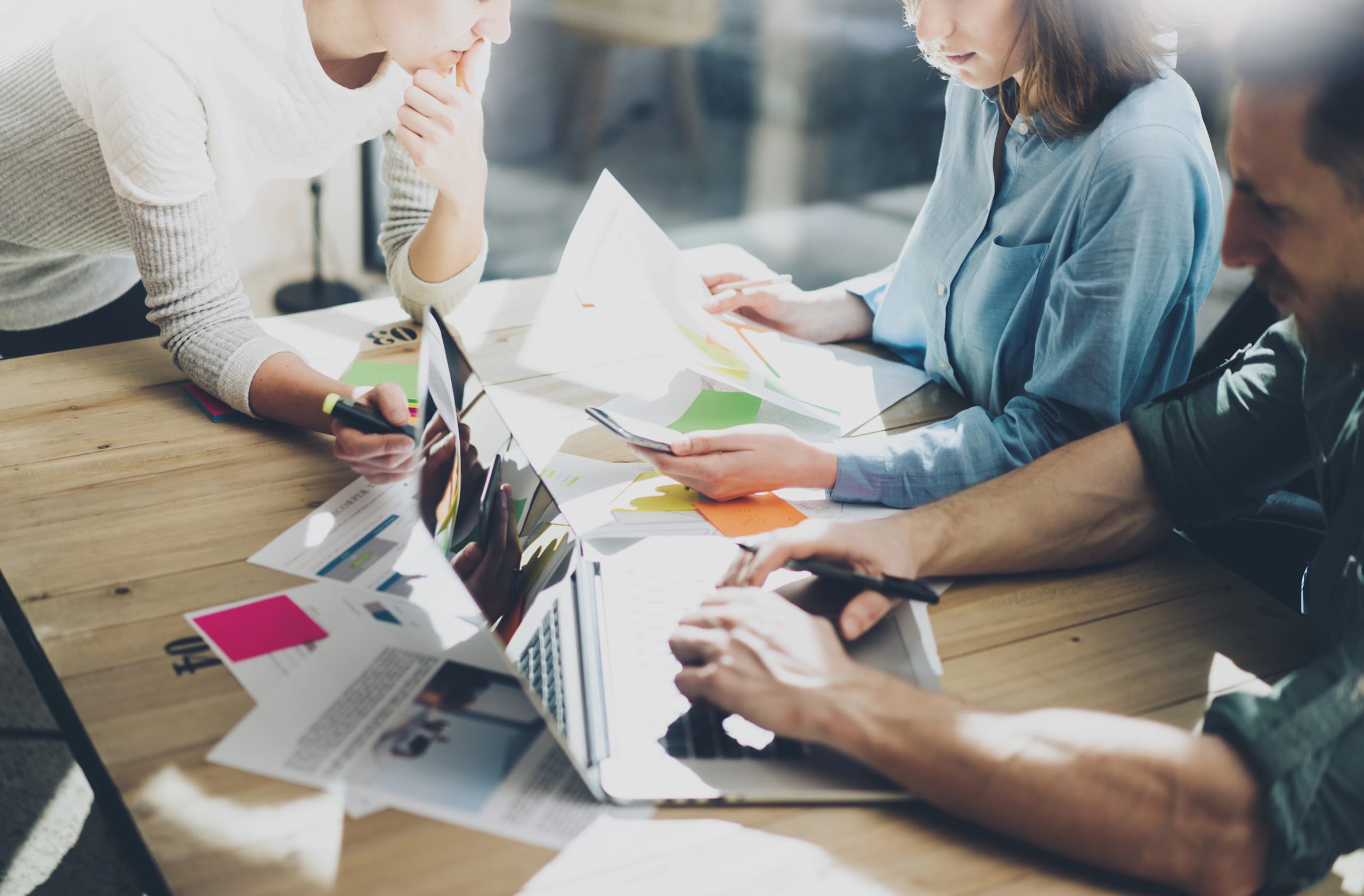 Employees working on a marketing plan collaboratively in the office