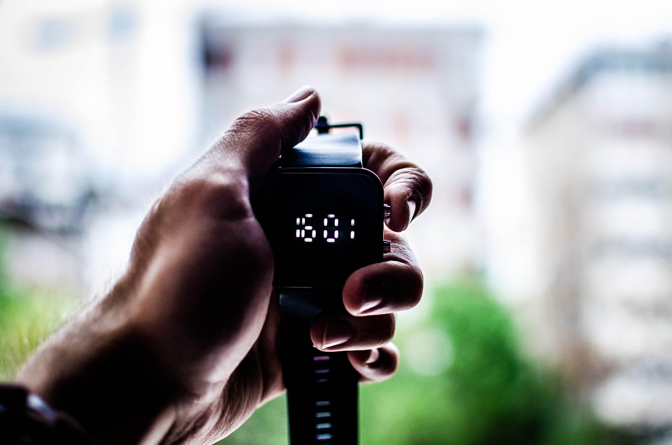 Hand holding a stop watch.