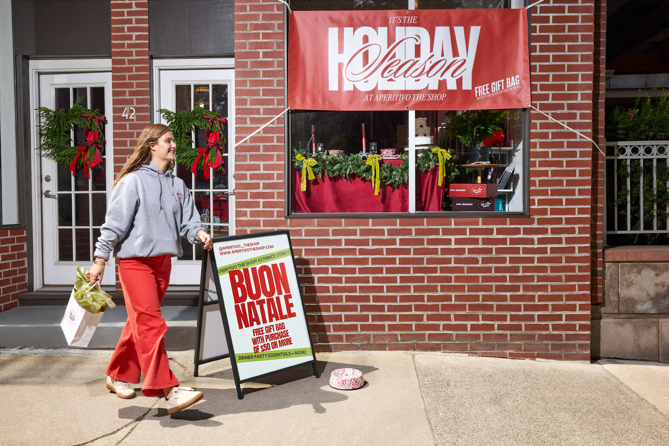 Storefront with branded banner and A-frame signage.