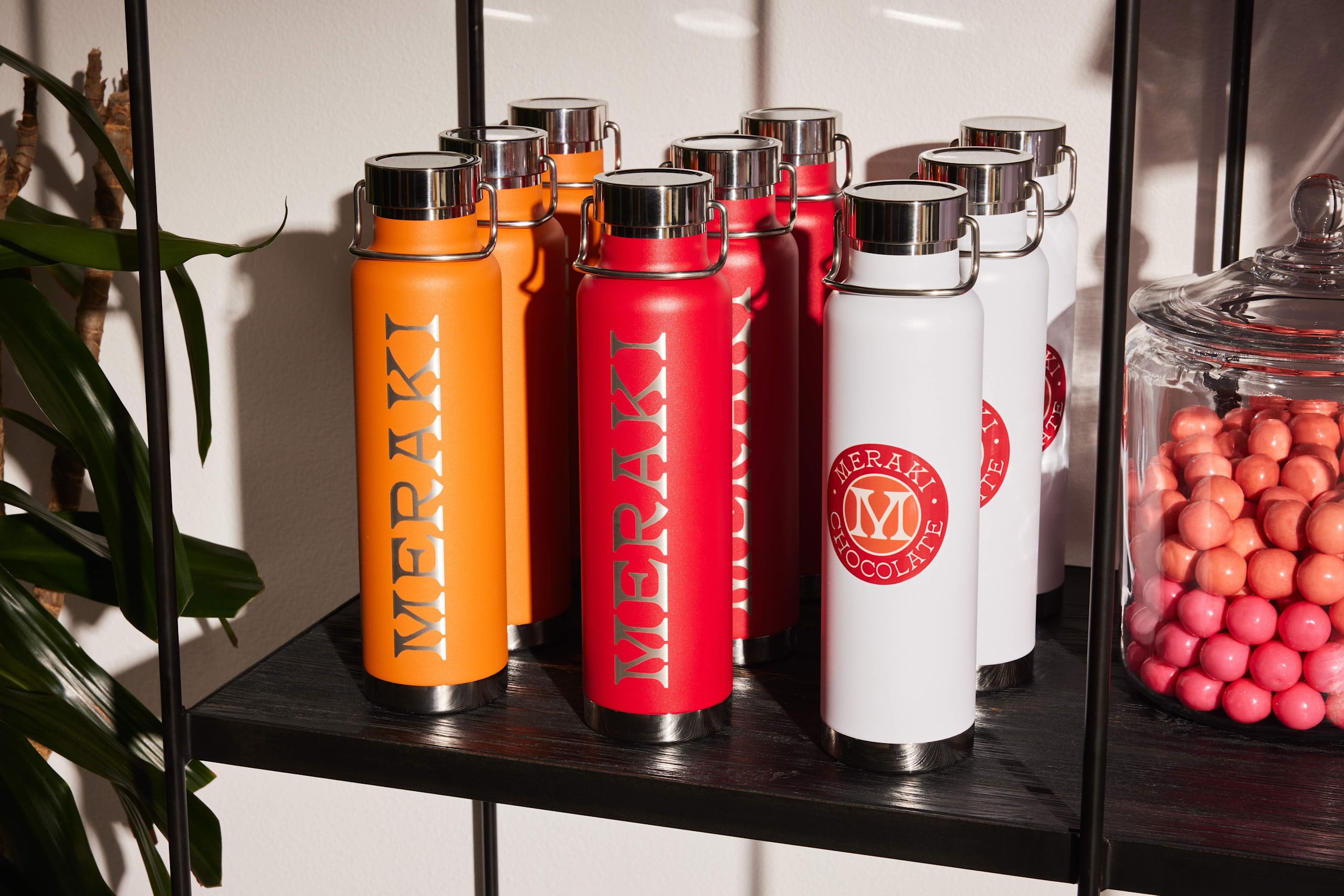 Personalized water bottles with a custom design on a shelf.