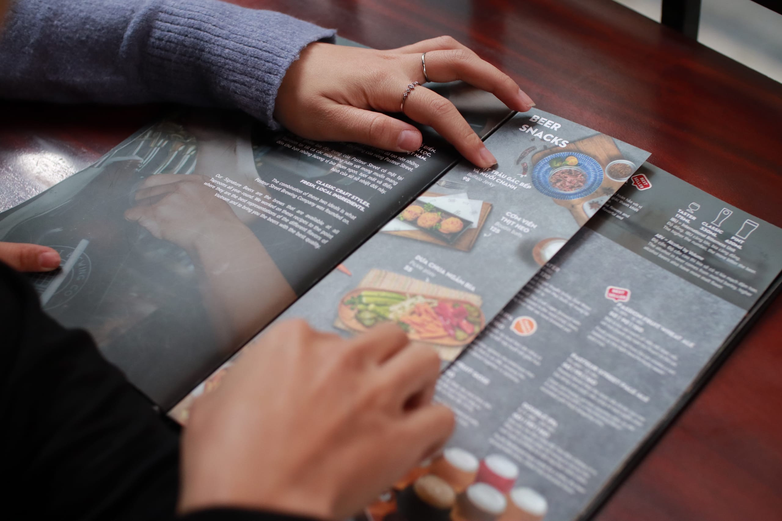Close-up of a takeaway menu with a person&rsquo;s hands in shot.