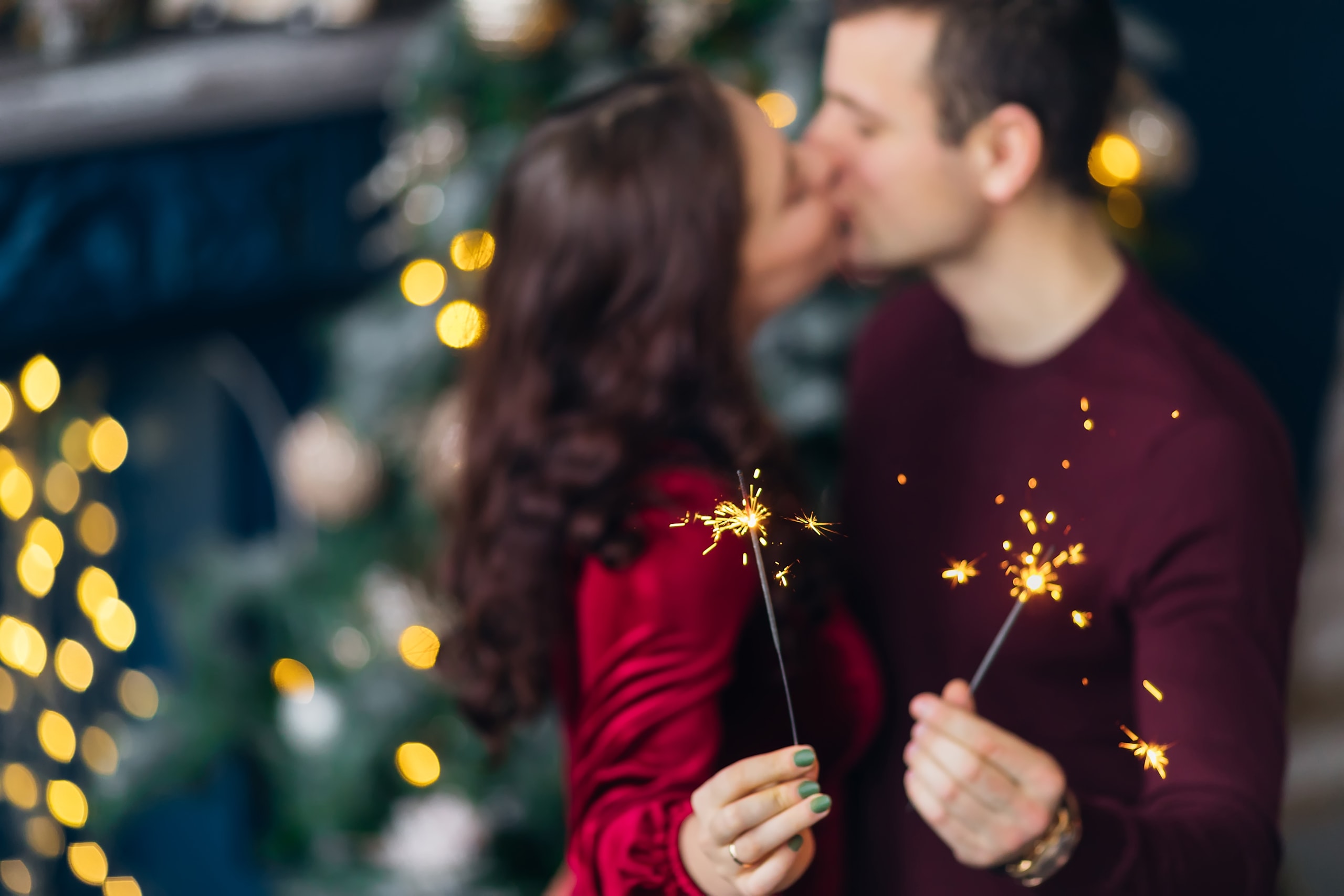 Couple in love kissing and holding sparklers