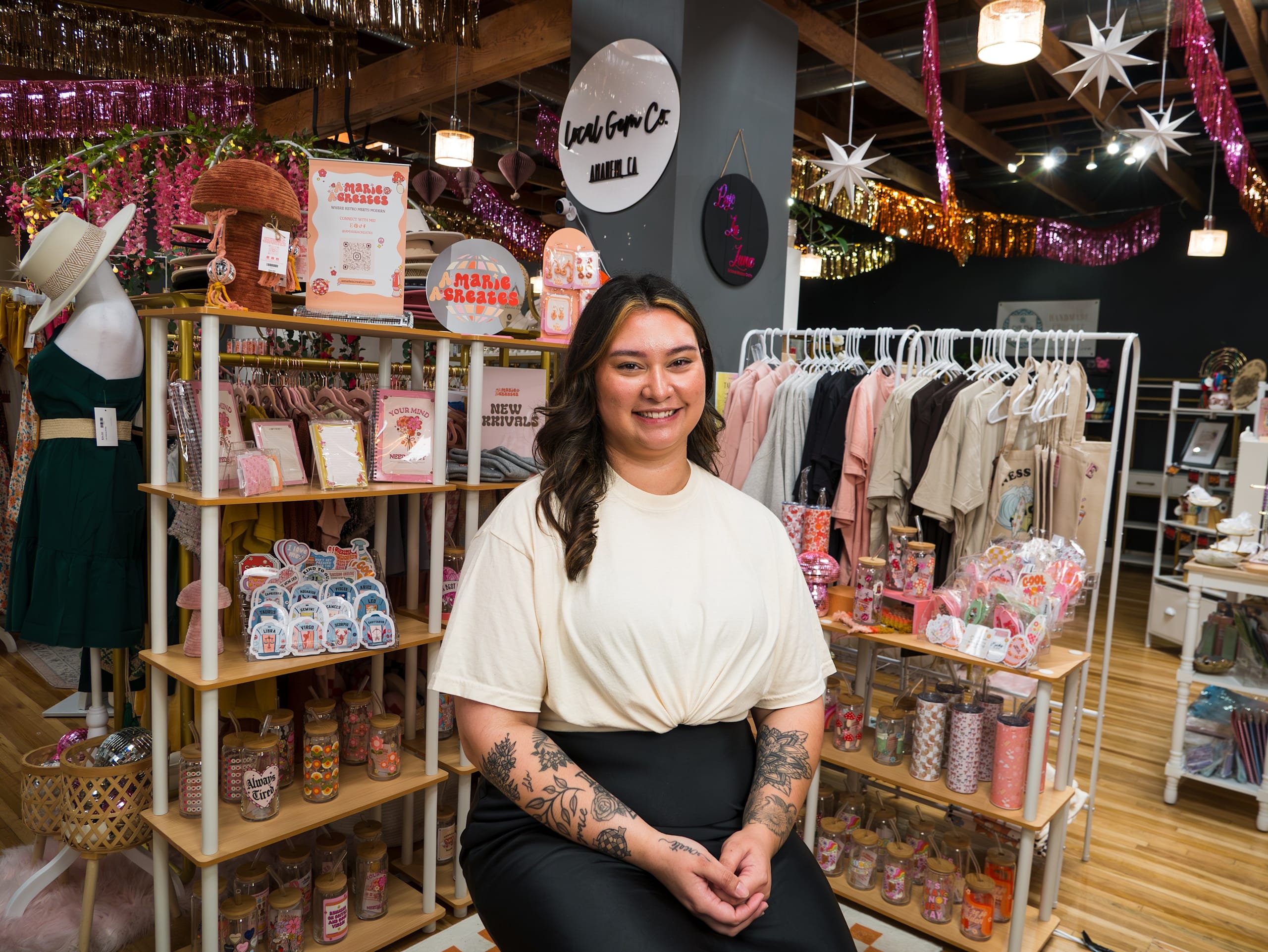 Owner of amariacreates sitting in front of her products.