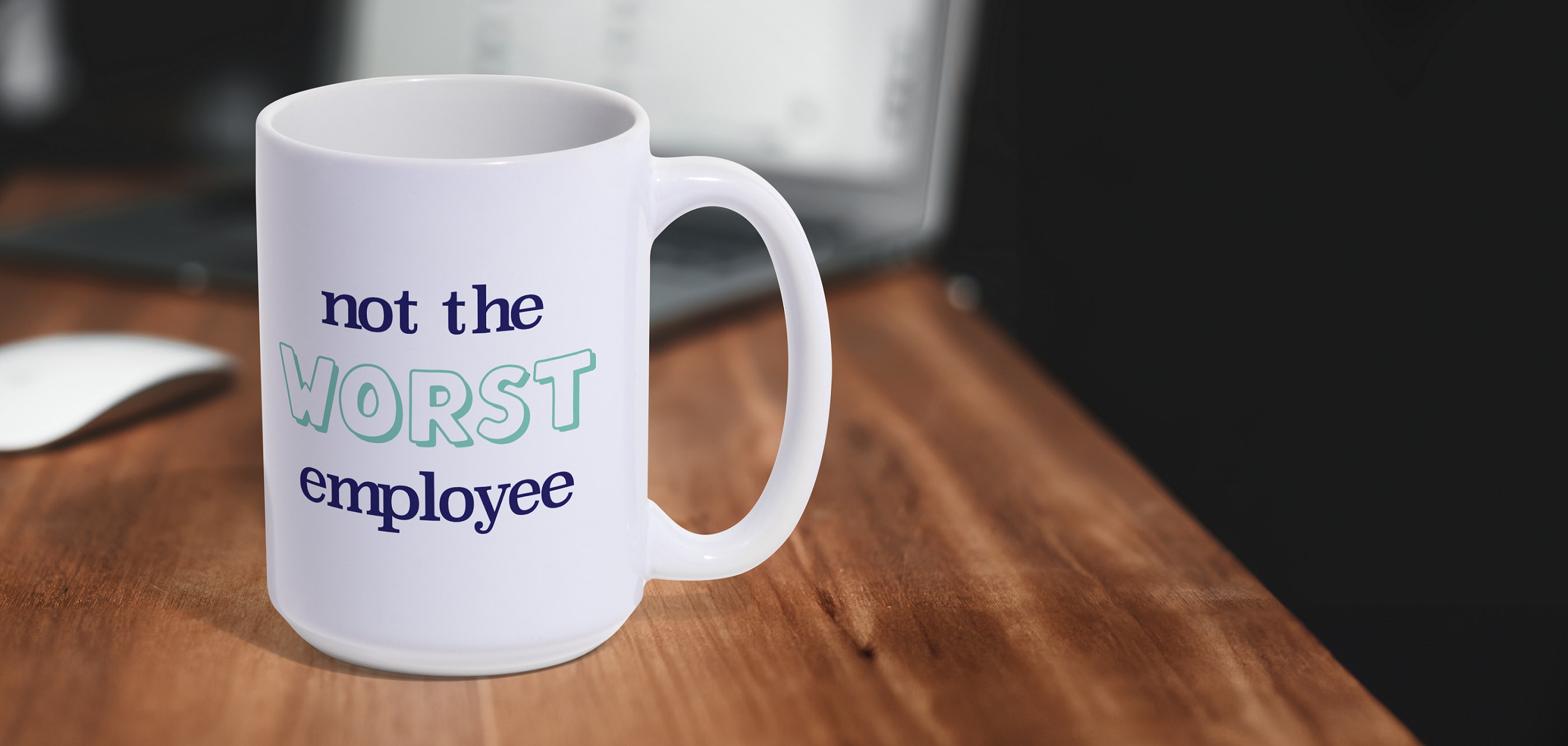 A custom mug that says “not the worst employee”