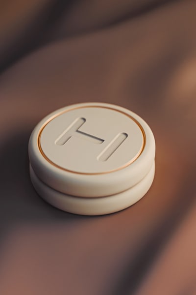 Round-shaped, ergonomic packaging in beige colors for a lipstick product, an example of the Ultra-Clean Industrial packaging trend 2026