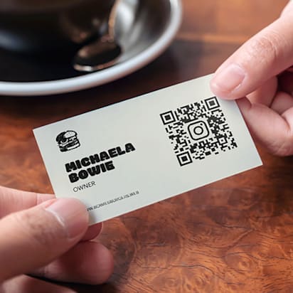Event qr codes example on business card being handed over to capture leads and drive engagement