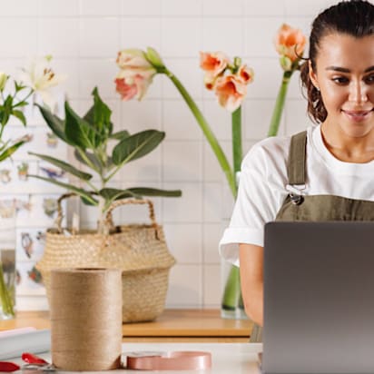 shop owner typing on laptop